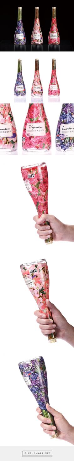 a woman's hand holding several vases with flowers on them