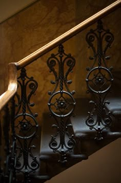 an iron stair rail with decorative designs on it