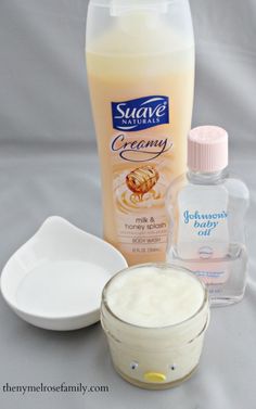 an assortment of skin care products on a white tablecloth with a spoon and bowl