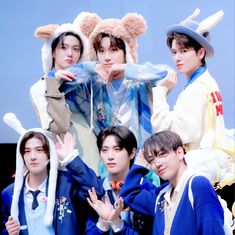 group of young men dressed in animal costumes posing for the camera with their hands up