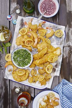 there are many different types of food on the table, including fried shrimp and other foods