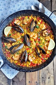 a skillet filled with seafood and corn