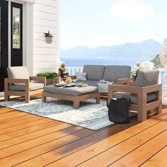 a living room filled with furniture on top of a wooden floor next to a door