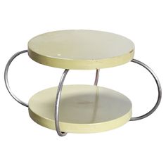 two tiered serving trays with circular metal handles and white plates on each side