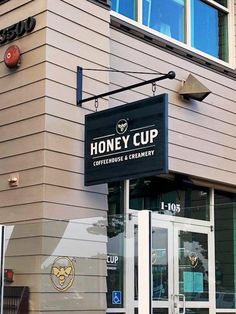 the honey cup coffeehouse and creamery is located on the corner of this building