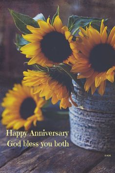 two sunflowers in a vase with the words happy anniversary god bless you both