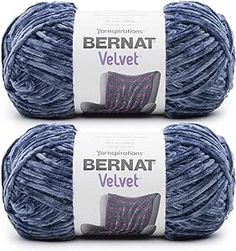 two balls of yarn with the words bernat velvet written on them in white and blue