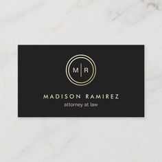 a black and gold business card with an elegant circle logo on the front, in white marble