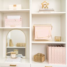 the shelves are filled with pink and gold items