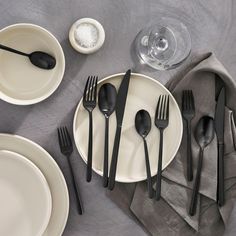 the table is set with black and white utensils