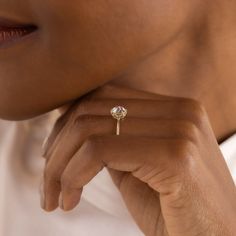 a close up of a person wearing a diamond ring