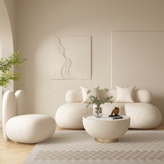 a living room filled with white furniture and plants on top of it's tables