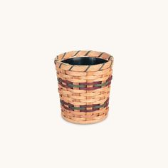 a woven basket is shown on a white background and it's brown, red, and green stripes