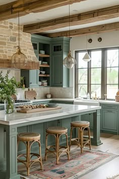 a large kitchen with green cabinets and white counter tops, two stools in front of the island