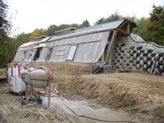 a house that has been built on top of dirt and is being moved by a truck