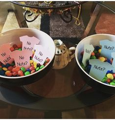 two bowls filled with candy sitting on top of a table