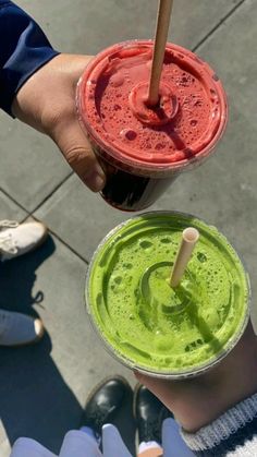 two people holding up drinks in their hands