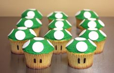 some cupcakes with green and white decorations on them