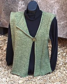 a green vest on display in front of a stone wall