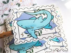 a stamp with an image of a shark on it and some other stickers next to it