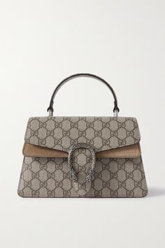 Gucci's 'Dionysus' bag earned its name from the ancient Greek god known to emulate the finer things in life. Elegant and endlessly versatile, this one is made from coated-canvas and trimmed with beige suede. It's fitted with a top handle and detachable strap so you can wear it by hand or crossbody. Gucci Dionysus Top Handle Bag, Gucci Beige Pouch Shoulder Bag, Pre-owned Luxury Gucci Shoulder Bag, Gucci Shoulder Bag With Gold-tone Hardware For Shopping, Luxury Gucci Bag With Gold-tone Hardware, Gucci Designer, Cold Weather Boots, Print Coat, Brown Coat