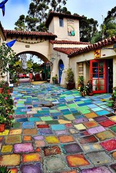 an outdoor courtyard with colorful tiles on the ground