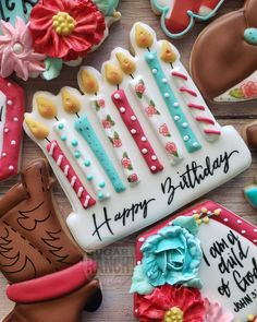 decorated birthday cookies are arranged on a table