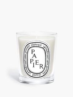 a candle that is sitting in front of a white background with the words paper on it