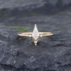 a diamond ring sitting on top of a rock