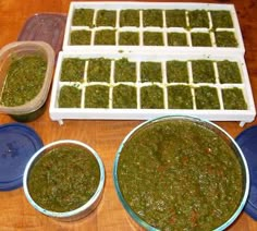 three bowls filled with green pesto next to two trays full of small containers