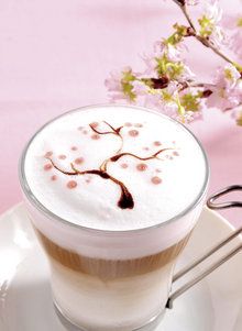 a cappuccino with cherry blossoms on it