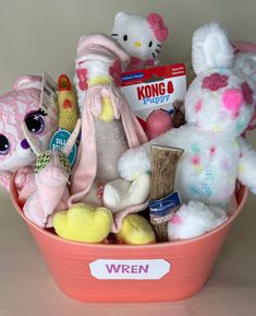 a pink basket filled with lots of stuffed animals