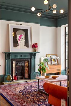 a living room filled with furniture and a painting hanging on the wall above a fire place