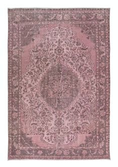 a pink rug with an intricate design on the center and sides, in various colors