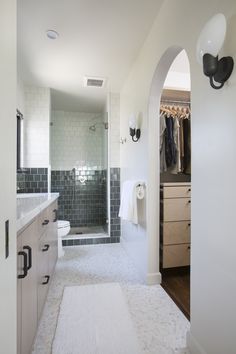 a large bathroom with a walk in shower next to a sink