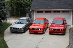 three cars parked next to each other in front of a garage