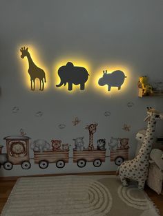 the children's room is decorated with animal wall decals and rugs in neutral colors