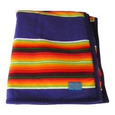 a multicolored blanket folded on top of each other