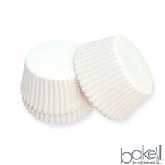 two white cups sitting next to each other on top of a white surface with the words bakel