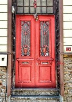 a red door with iron bars on it