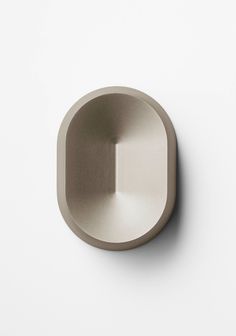 an empty metal object on a white surface