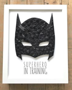 a paper cut batman mask with the words'superhero in training'written below it