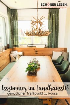 a dining room table with green chairs and a wooden bench in front of the window