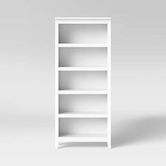 an empty white bookcase on a gray background