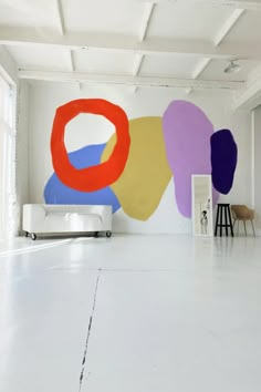 an empty room with paintings on the wall