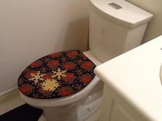 a white toilet sitting in a bathroom next to a sink with a mirror above it