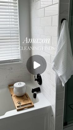 a bath room with a toilet and a sink next to a shower head mounted on a wall