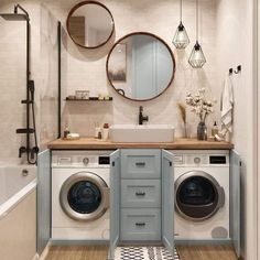 a washer and dryer in a bathroom next to a bathtub with two mirrors on the wall