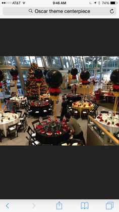 a room filled with lots of tables covered in black and red decorations