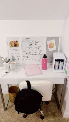 a white desk topped with a black backpack